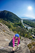 Woman climbing on Gneiss rock, Placca di Tegna, Ponte Brolla, Ticino, Switzerland
