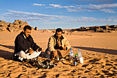beduins having breakfast at campfire, Akakus mountains, Libya, Africa