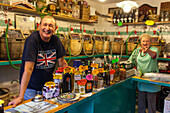 Vino Sfuso, wine shop, Alberto Digli with his wife Heidrun, fill up bottles brought in by customers, Venice Italy