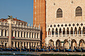 facade, Doge's Palace, column with Lion of Venice, museum, historic landmark, Venetian Gothic architecture, view from Grand Canal, gondolas, lagoon, Venice, Italy