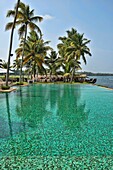 luxury resort swimming pool in the backwaters of Kerala, India.