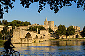 View of Pont d'Avignon (or Pont St Benezet) and Rhone river towards the Papes Palace in the early evening, Avignon city, in Provenza-Alpes-Cotes d'Azur region, France.