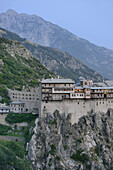 Greece, Chalkidiki, Mount Athos peninsula, listed as World Heritage, Simonos Petra monastery and Mount Athos at dusk.
