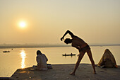 India, Uttar Pradesh, Varanasi, Yogi practising at sunrise.