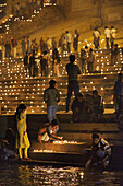 India, Uttar Pradesh, Varanasi, Dev Deepawali festival, Hindu devotees lighting oil lamps.