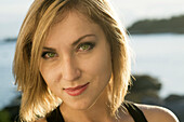 Blonde young woman on beach in Maine.