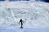 Hawaii, Oahu, North Shore, Surfer Riding In Front Of A Giant Wave.