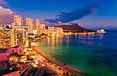Hawaii, Oahu, Waikiki, View Of Hotels Along Ocean And Diamond Head In The Evening.