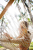 Hawaii, Oahu, Attractive Young Woman Laying In A Hammock.