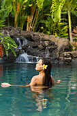 Hawaii, Oahu, Young Woman Relaxing In Tropical Pool.