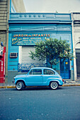 Old Blue Car Parked In Front Of A Blue Building, Buenos Aires, Argentina