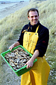 Jean-Paul Juernier With Oyster In Agon Coutainville In La Manche, Normandy. One Out Of Four Opyster Eaten In France Comes From Normandy, France, Europe.