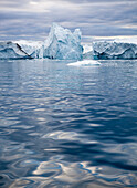 A Midnight Cruise Around The Ilulissat Ice Fjord, One Of Unesco World Heritage Sites. Greenland.