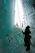 Ice climber in a waterfall cave in Thompson Pass, Valdez, Alaska