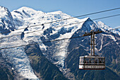 'Cable car heading to Le Brevent, above Chamonix-Mont Blanc valley, with Mont Blanc mountain in background; France'