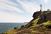 'Tourists at a lighthouse on Cape Spear; St. John's, Newfoundland and Labrador, Canada'