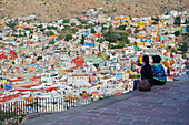 'Two women viewing the cityscape of Guanajuato; Guanajuato, Mexico'
