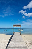 'Wooden boardwalk over the white sand leading to the ocean; Mauritius'