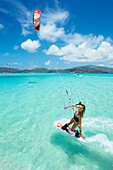 'Professional kiteboarder Susi Mai kitesurfing over the crystal blue waters, Necker Island, British Virgin Islands'