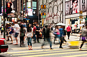 'Pedestrians crossing a street; Hong Kong, China'