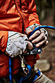 'Man adjusting rock climbing equipment in the Adirondacks; New York, USA'