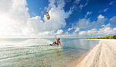 'Kiteboarding in tropical lagoon in the South Pacific at sunset, Tikehau, French Polynesia'