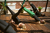 A group perform aerial yoga in San Diego California.