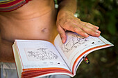 In?™s Couto-Soares, looking at a climbing guide in a summer day at Rodellar, Spain