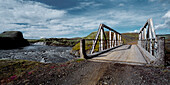 single track bridge over a glacial river close to the Myrdalsjokull glacier
