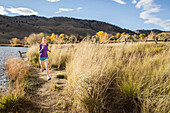 Female running outside by a lake in Boulder, Colorado