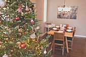 Christmas tree and dining room in a residential house.