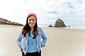 Portrail of a young lady smiling while on Cannon Beach in Oregon.