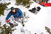 A backcountry skier cooking in Glacier National Park, Montana.