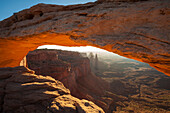 Sunrise on Mesa Arch in the Island in the Sky mesa in Utah's Canyonlands National Park.