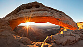 Sunrise on Mesa Arch in the Island in the Sky mesa in Utah's Canyonlands National Park.