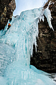 Man lead climbing an ice fall in Simplon Pass, Valais, Switzerland.