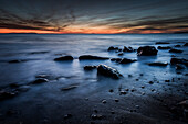 'Glowing orange horizon at sunset over the ocean; Tarifa, Costa de la Luz, Cadiz, Andalusia, Spain'