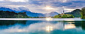 Lake Bled at sunrise with the Church on Lake Bled Island and Bled Castle, Gorenjska Region, Slovenia, Europe