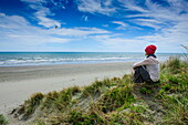 Woman enjoying the view over Foxton beach, Kapiti Coast, North Island, New Zealand, Pacific