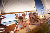Children in a sailing boat on lake Starnberg, Upper Bavaria, Bavaria, Germany