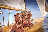 Three girls in a sailing boat on lake Starnberg, Upper Bavaria, Bavaria, Germany