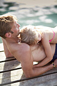 Father and daughter on a jetty at lake Starnberg, Upper Bavaria, Bavaria, Germany