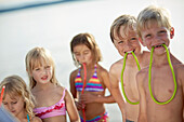 Children eating fruitgum sticks, lake Starnberg, Upper Bavaria, Bavaria, Germany