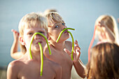 Two boys with fruitgum sticks, lake Starnberg, Upper Bavaria, Bavaria, Germany