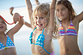 Three girls with fruitgum sticks, lake Starnberg, Upper Bavaria, Bavaria, Germany