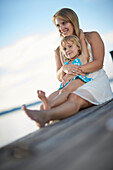 Mother and daughter on a jetty at lake Starnberg, Upper Bavaria, Bavaria, Germany