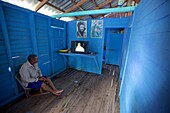 Cuban fischerman watching television in his hut, Cuba, Antilles, Carribean