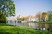 Lawn on river Obertrave with view to historic city, Lubeck, Schleswig-Holstein, Germany