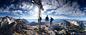 Hikers on summit of mount Stempeljochspitze, Karwendel, Tyrol, Austria