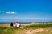 Family looking out to sea, Amrum Island, North Frisian Islands, Schleswig-Holstein, Germany